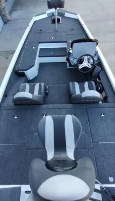 Slide: The Image of 2026 Vexus AVX181D boat interior with gray seating and steering console. - 12