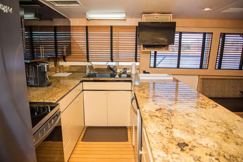 Slide: The Image of Kitchen on a 1989 Broward 85 Raised Pilothouse yacht with granite countertops. - 46