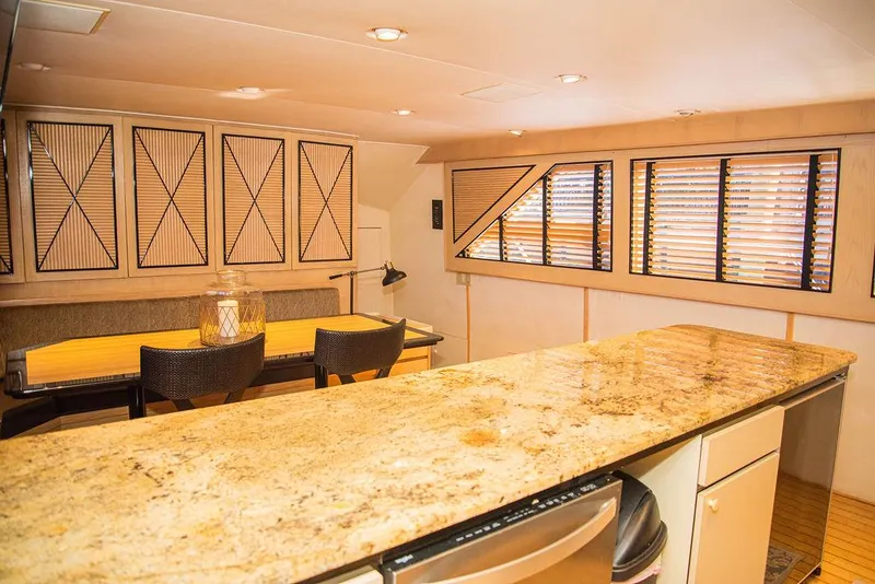 Slide: The Image of Interior of Broward 85 Raised Pilothouse yacht, kitchen with granite countertop. - 47