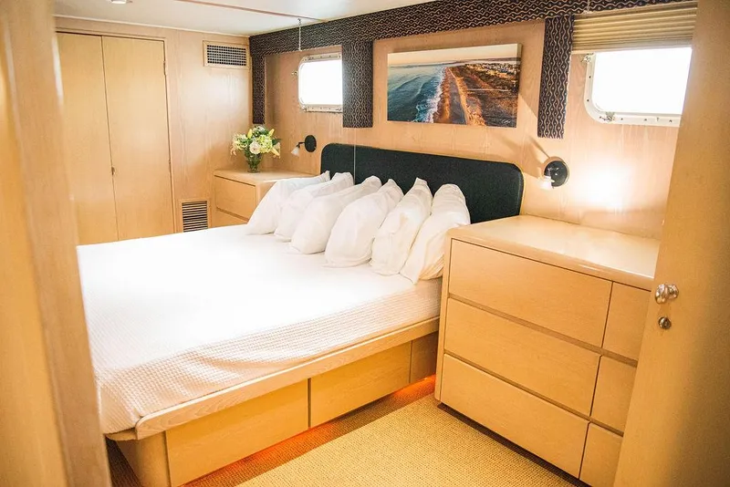 Slide: The Image of Luxurious bedroom on a 1989 Broward 85 yacht. - 49