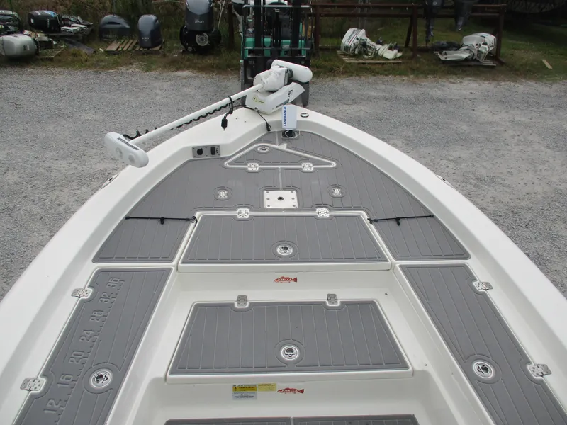Slide: The Image of 2015 NauticStar 224 boat deck with trolling motor and storage compartments. - 4