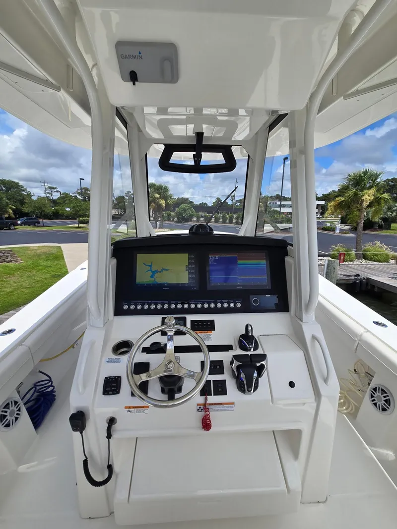 Slide: The Image of 2023 Regulator 34 boat helm with advanced navigation system and controls. - 14