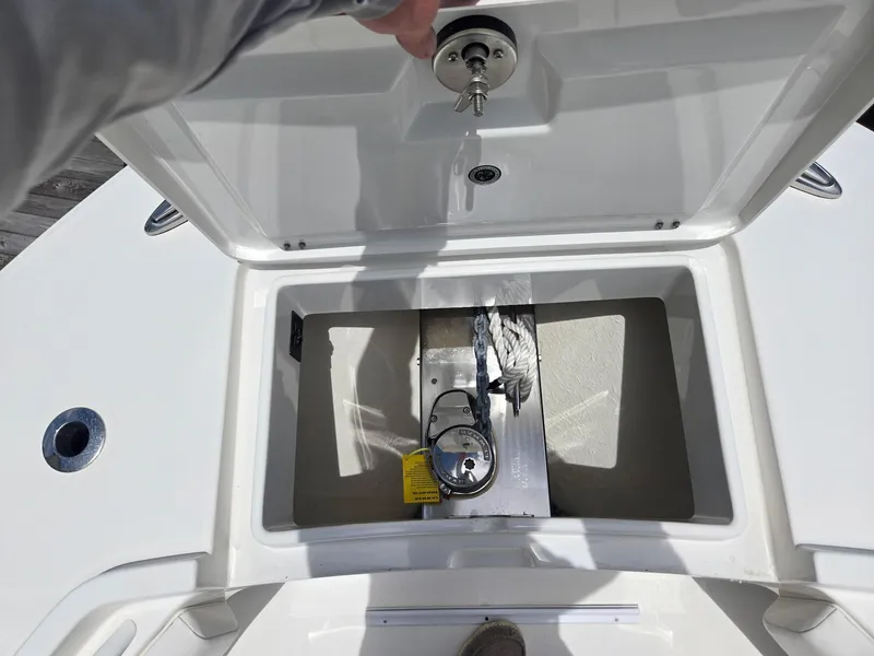 Slide: The Image of 2023 Regulator 34 boat anchor storage compartment with chain and rope. - 17