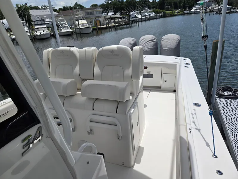 Slide: The Image of 2023 Regulator 34 boat interior with white seating, docked at marina. - 22