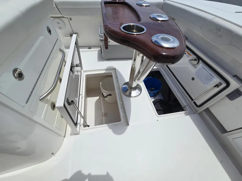 Slide: The Image of 2023 Regulator 34 boat interior with storage compartments and wooden table. - 26