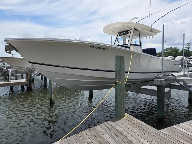 Slide: The Image of 2023 Regulator 34 boat docked at marina, side view. - 6