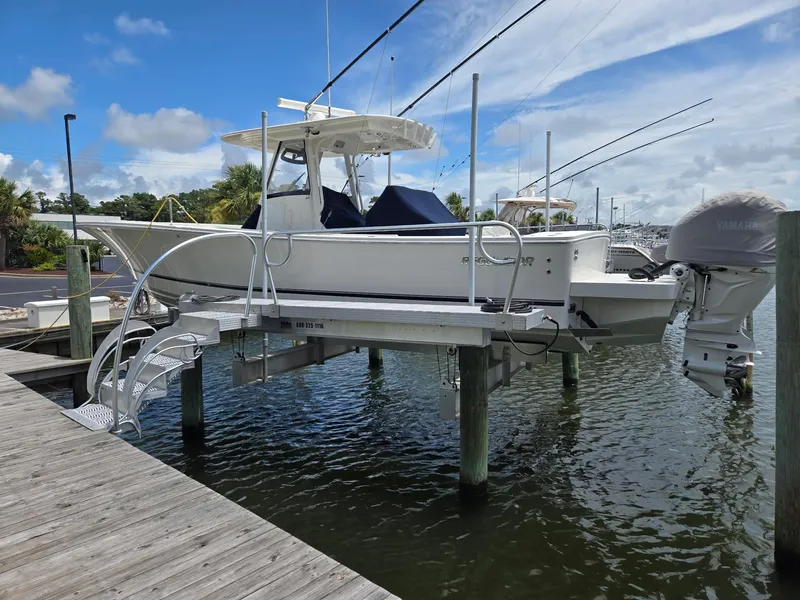 Slide: The Image of 2023 Regulator 34 boat on lift at marina, clear sky background. - 8