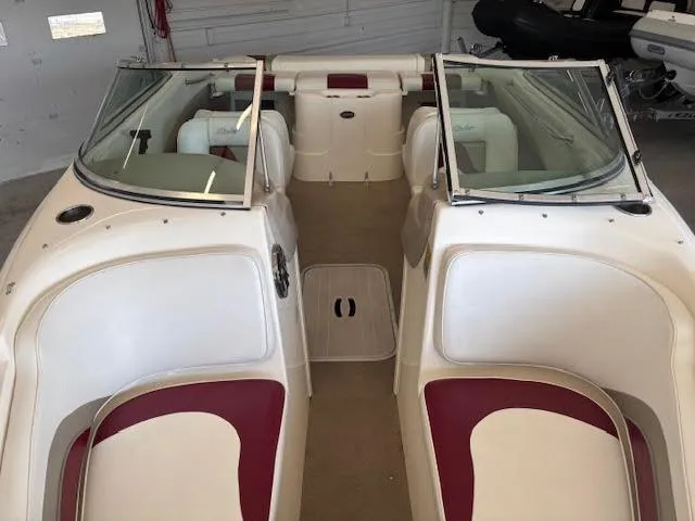 Slide: The Image of 2000 Rinker Captiva 212 boat interior with red and white seating, open bow design. - 12