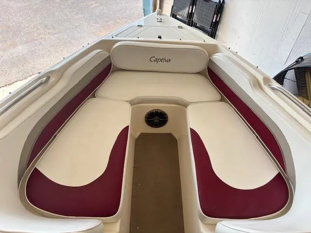 Slide: The Image of 2000 Rinker Captiva 212 boat interior with white and maroon seating. - 13