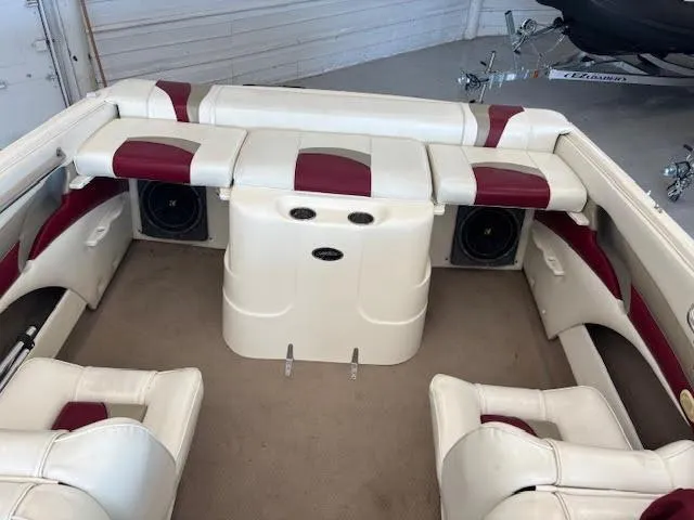 Slide: The Image of Interior of a 2000 Rinker Captiva 212 boat with white and red seating. - 16