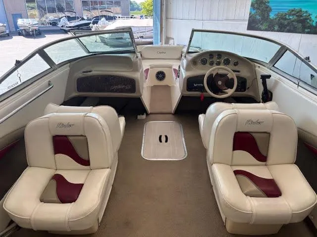 Slide: The Image of Interior of a 2000 Rinker Captiva 212 boat with white and red seating. - 20
