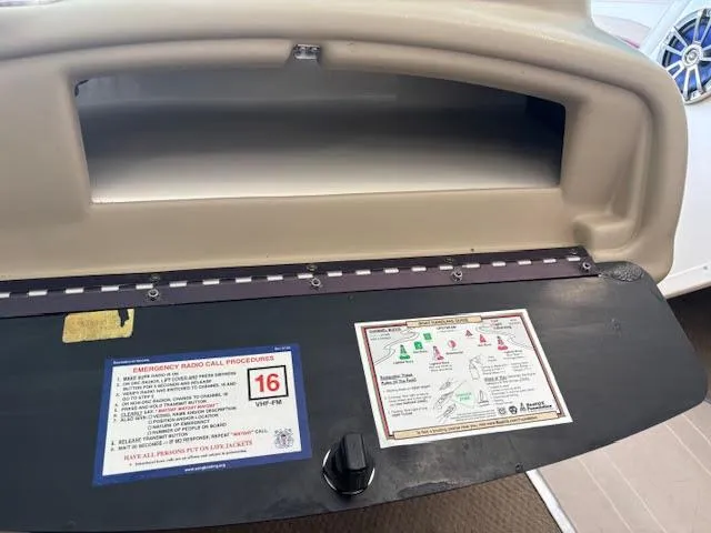 Slide: The Image of 2000 Rinker Captiva 212 dashboard with emergency radio call procedures and safety instructions. - 23