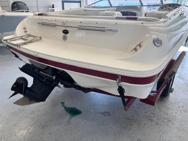 Slide: The Image of 2000 Rinker Captiva 212 boat on trailer, rear view in indoor storage. - 5