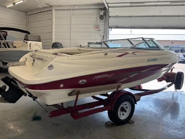 Slide: The Image of 2000 Rinker Captiva 212 boat on trailer in indoor storage facility. - 6