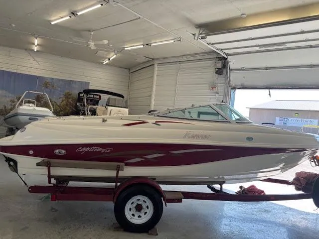 Slide: The Image of 2000 Rinker Captiva 212 boat on trailer in a garage setting. - 8
