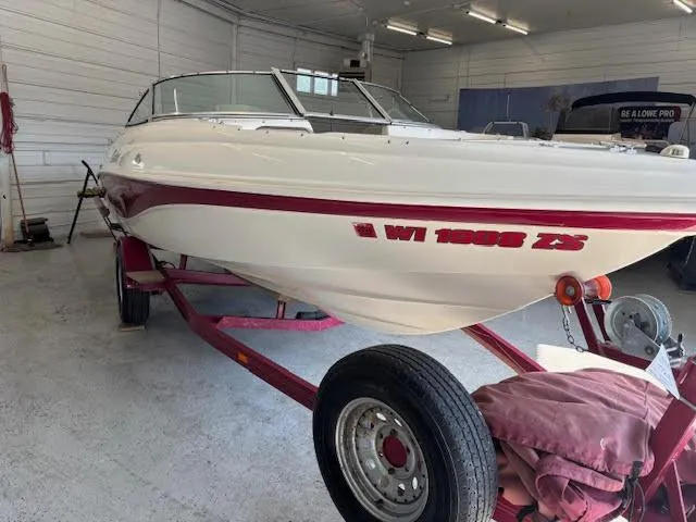 Slide: The Image of 2000 Rinker Captiva 212 boat on trailer in garage setting. - 9