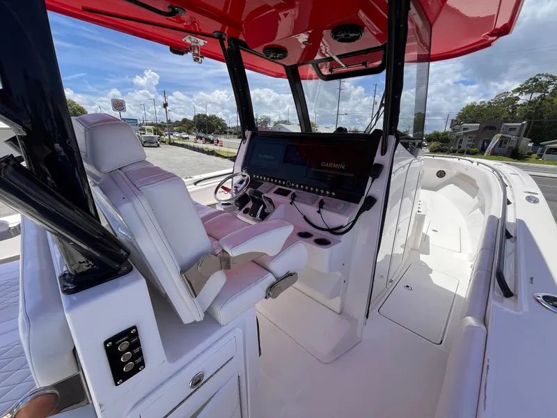 Slide: The Image of 2023 Fountain 38 Tournament Edition boat interior with red canopy and advanced navigation system. - 10