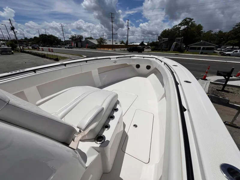Slide: The Image of 2023 Fountain 38 Tournament Edition boat, white interior, parked outdoors under cloudy sky. - 14