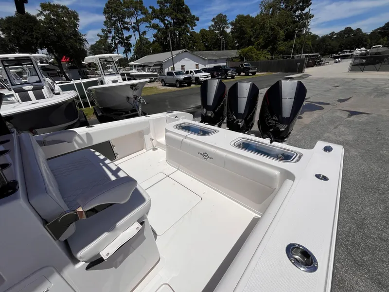Slide: The Image of 2023 Fountain 38 Tournament Edition boat with triple outboard engines, docked outdoors. - 20