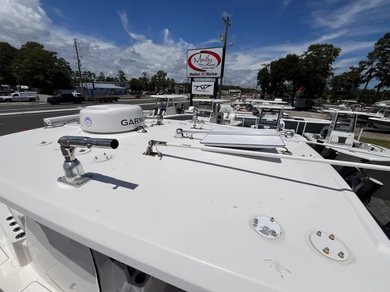 Slide: The Image of 2023 Fountain 38 Tournament Edition boat on display at a marina under a clear sky. - 21
