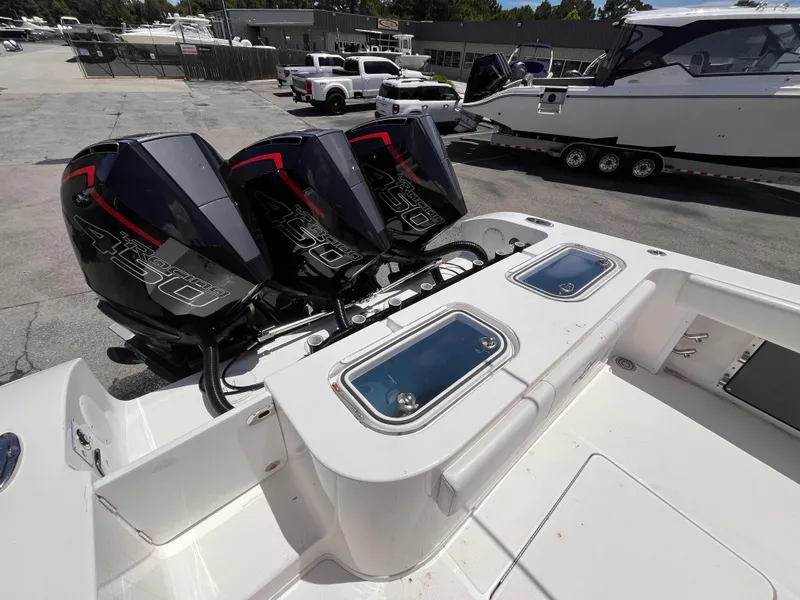 Slide: The Image of 2023 Fountain 38 Tournament Edition boat with triple 450 horsepower engines at a marina. - 7