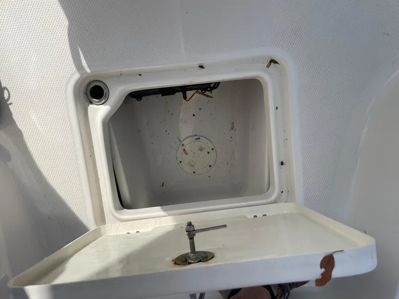 Slide: The Image of Open storage compartment on 2024 Robalo 226 Cayman boat, showing interior details. - 14