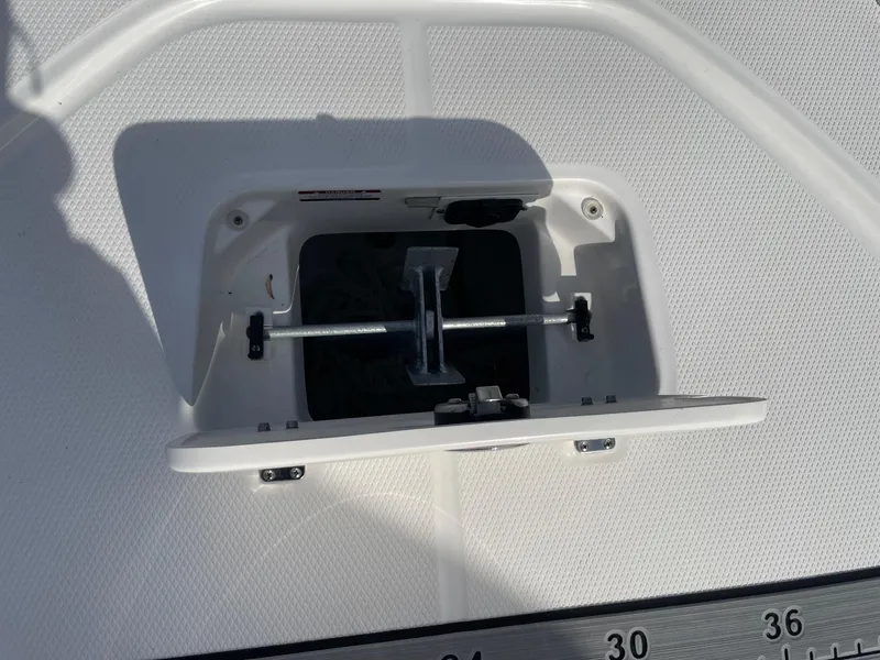Slide: The Image of 2024 Robalo 226 Cayman boat anchor compartment with open hatch. - 15