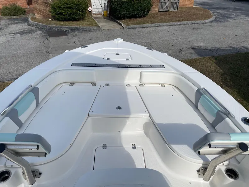 Slide: The Image of 2024 Robalo 226 Cayman boat deck with seating and storage compartments. - 17