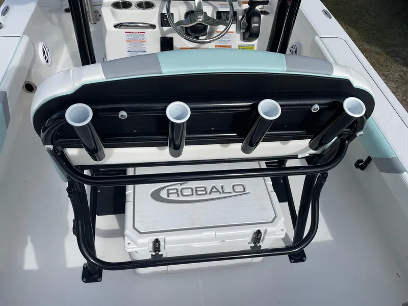 Slide: The Image of 2024 Robalo 226 Cayman boat interior with rod holders and branded cooler. - 18