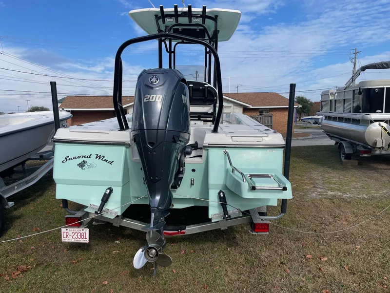 Slide: The Image of 2024 Robalo 226 Cayman boat with Yamaha 200 engine, parked on grass. - 3