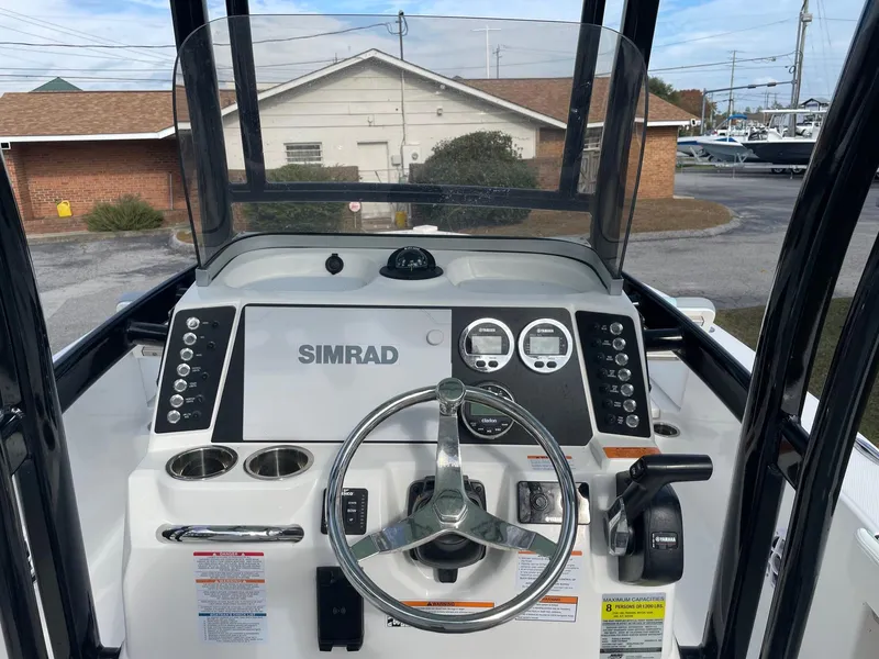 Slide: The Image of 2024 Robalo 226 Cayman boat dashboard with Simrad display and Yamaha controls. - 5