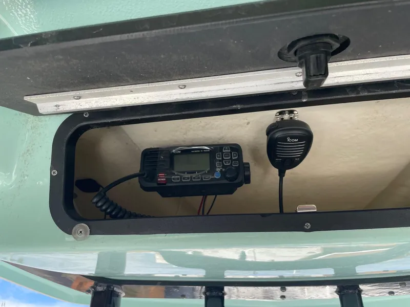 Slide: The Image of 2024 Robalo 226 Cayman boat radio compartment with Icom communication device. - 7