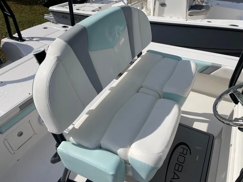 Slide: The Image of 2024 Robalo 226 Cayman boat seat with white and teal upholstery. - 8