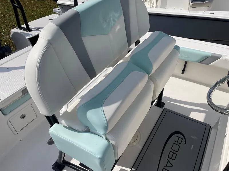 Slide: The Image of 2024 Robalo 226 Cayman boat interior with cushioned seating and logo mat. - 9