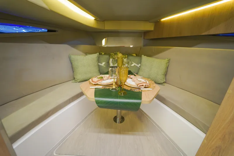 Slide: The Image of Luxurious interior of 2024 NX Boats NX360 Sports Coupe with elegant dining setup. - 10