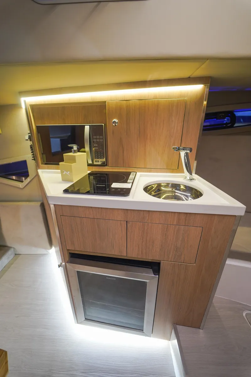 Slide: The Image of 2024 NX Boats NX360 Sports Coupe kitchen area with modern amenities. - 11