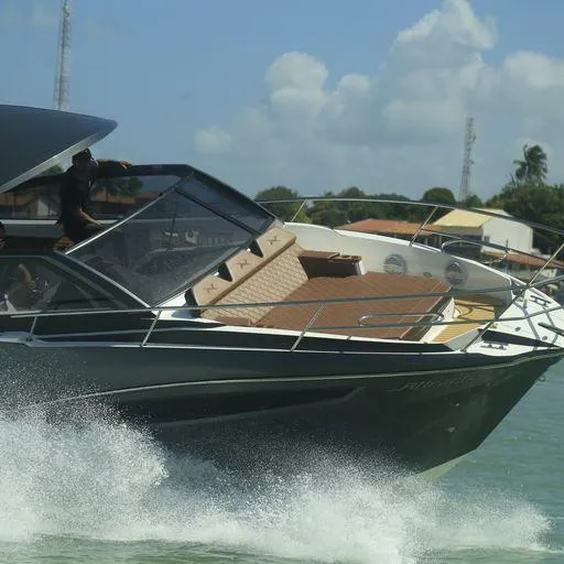 Slide: The Image of 2024 NX Boats NX360 Sports Coupe cruising on water. - 14