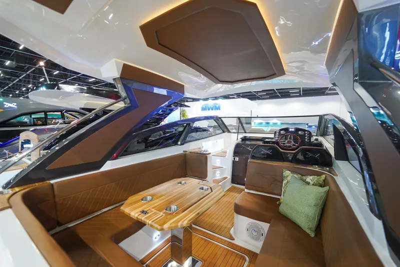 Slide: The Image of 2024 NX Boats NX360 Sports Coupe interior with luxurious seating and modern design. - 5