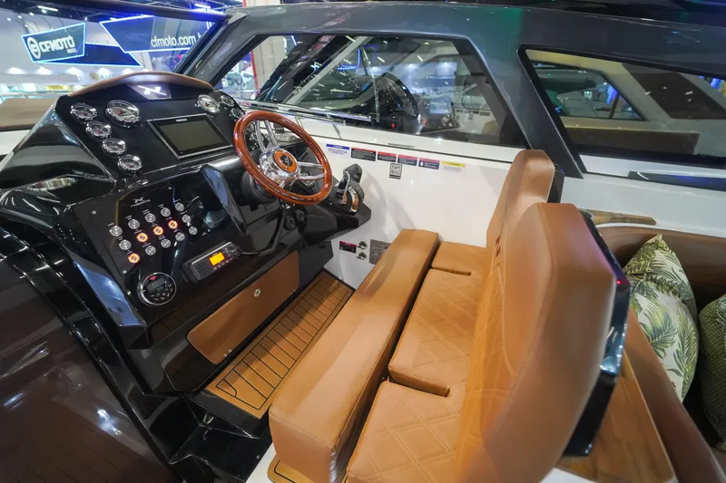 Slide: The Image of 2024 NX Boats NX360 Sports Coupe cockpit with leather seats and advanced control panel. - 7