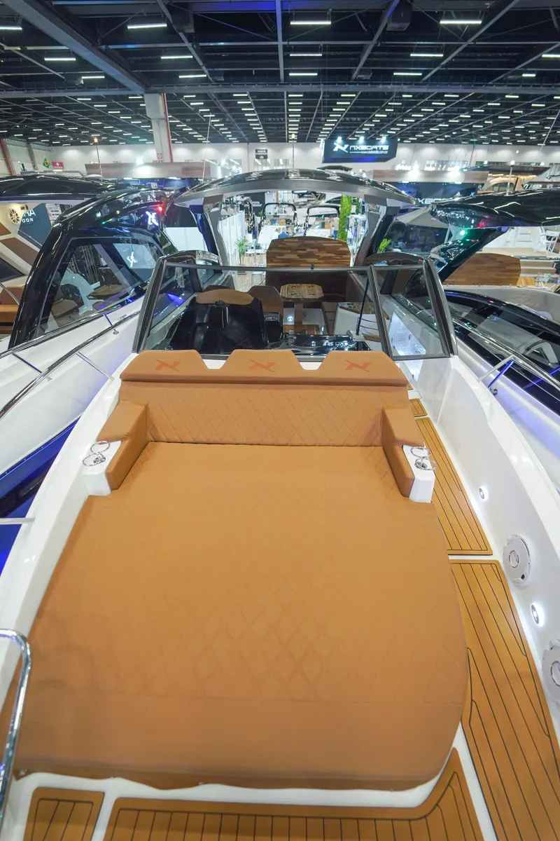 Slide: The Image of 2024 NX Boats NX360 Sports Coupe luxury deck at a boat show. - 8