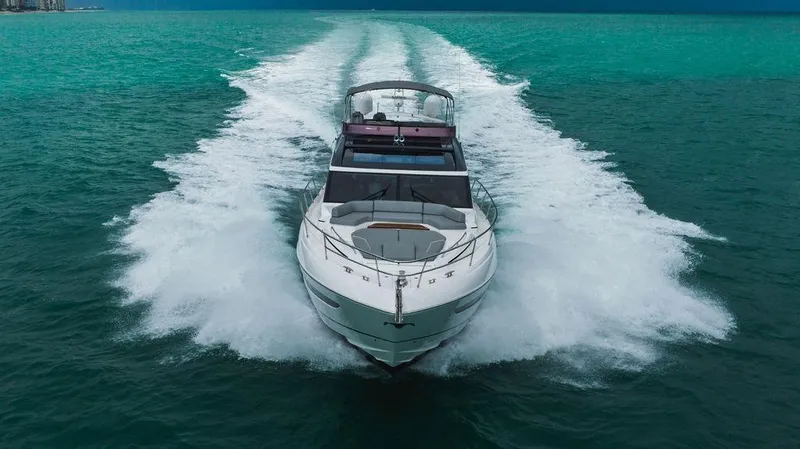 Slide: The Image of 2022 Princess S66 yacht cruising on turquoise waters, creating a dynamic wake. - 16