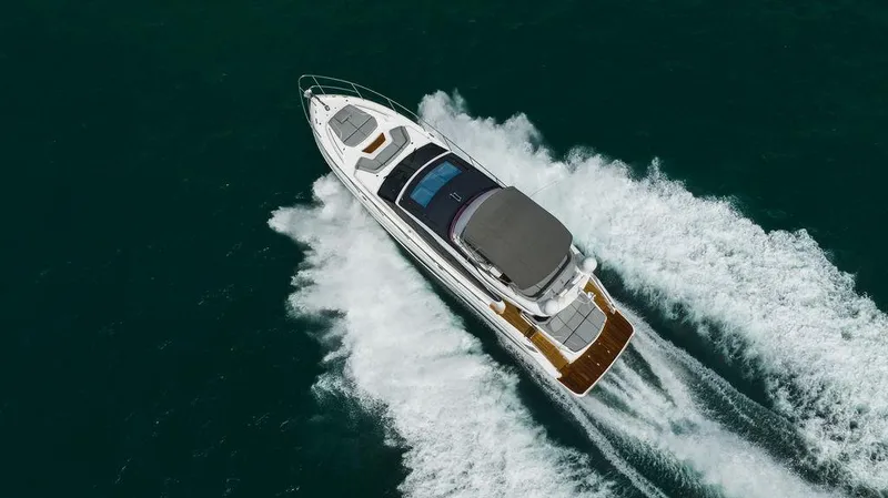 Slide: The Image of Luxury 2022 Princess S66 yacht cruising on open water, aerial view. - 21