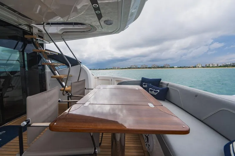 Slide: The Image of Luxury yacht Princess S66 deck with wooden table, chairs, and ocean view, 2022 model. - 43