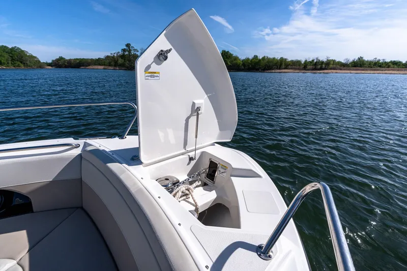Slide: The Image of Boston Whaler 240 Vantage 2022 boat with open storage compartment on a sunny day. - 15