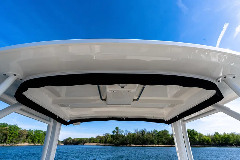 Slide: The Image of Boston Whaler 240 Vantage 2022 boat canopy against blue sky and water backdrop. - 16