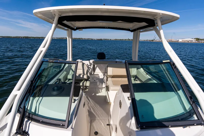 Slide: The Image of 2022 Boston Whaler 240 Vantage boat on open water, featuring spacious seating and clear skies. - 18