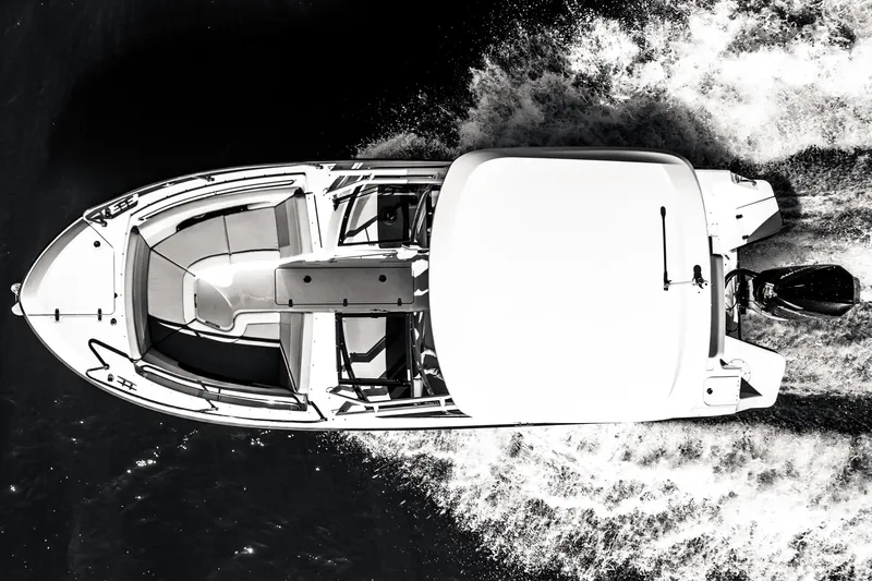Slide: The Image of Overhead view of 2022 Boston Whaler 240 Vantage boat cruising on water. - 5