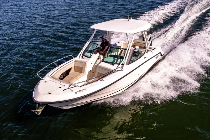 Slide: The Image of 2022 Boston Whaler 240 Vantage cruising on open water, showcasing sleek design and performance. - 6