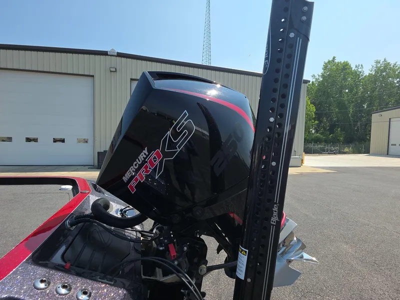 Slide: The Image of 2023 Ranger Z520R 55th Anniversary boat with Mercury Pro XS engine, parked outdoors. - 5