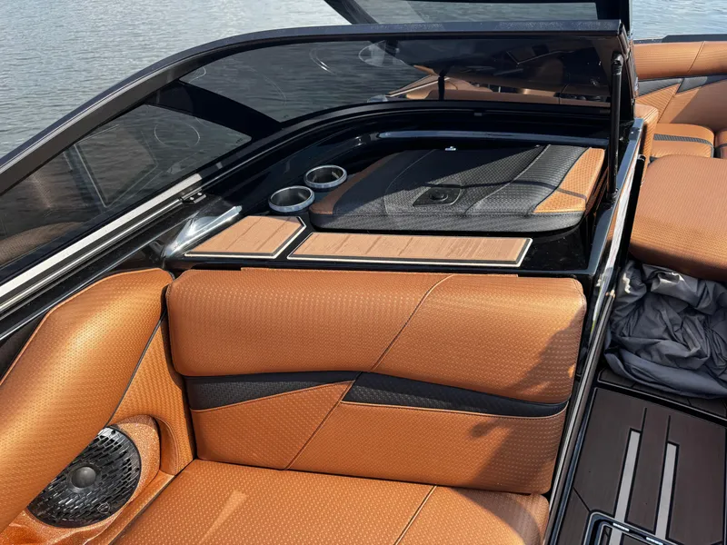 Slide: The Image of 2022 Centurion Fi23 boat interior with tan leather seats and cup holders. - 14